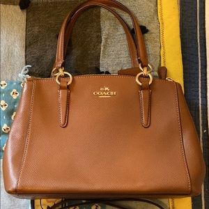 Coach purse. Double small handle and comes with cross body strap.